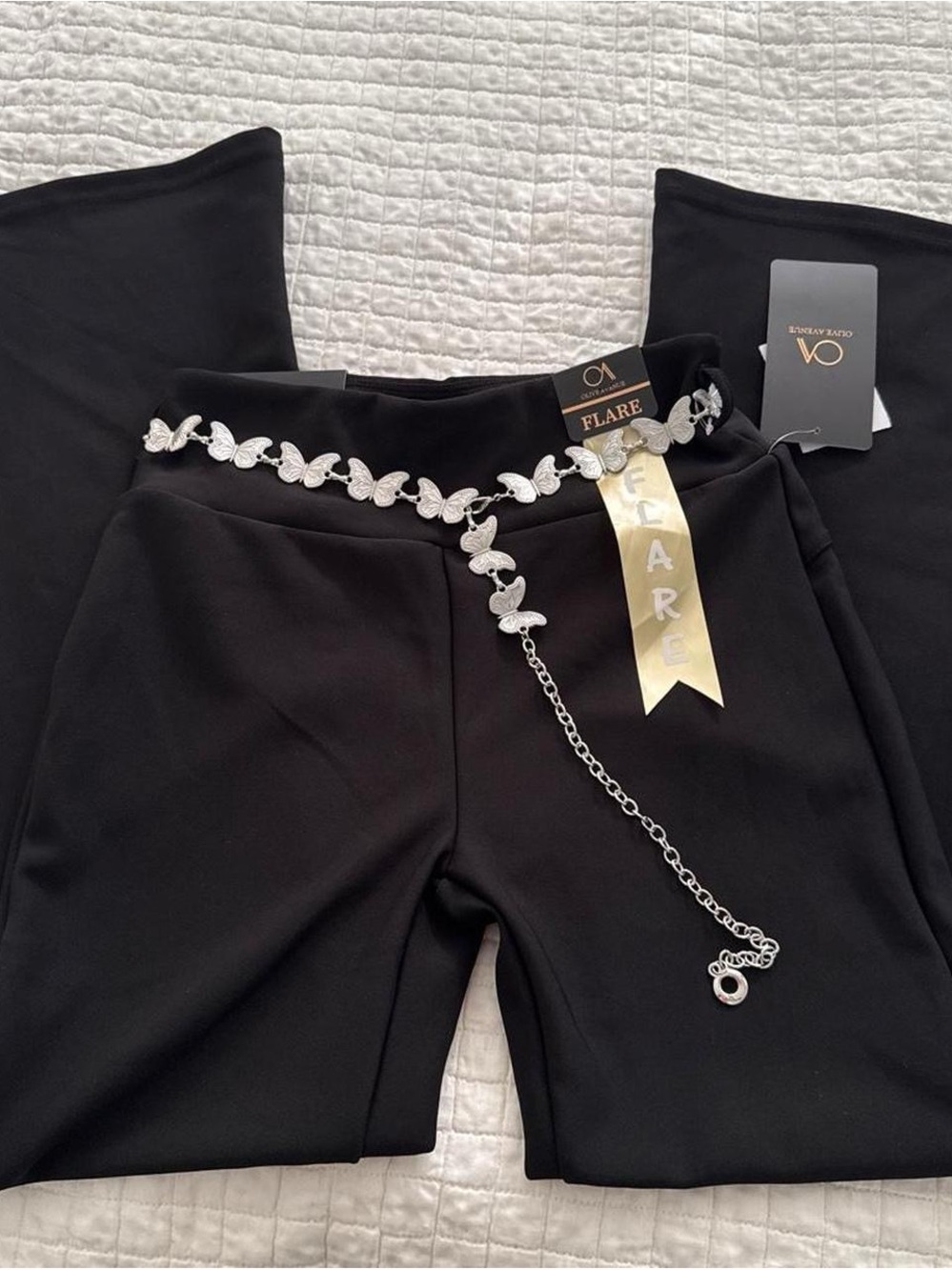Black flare pants with silver butterfly chain belt